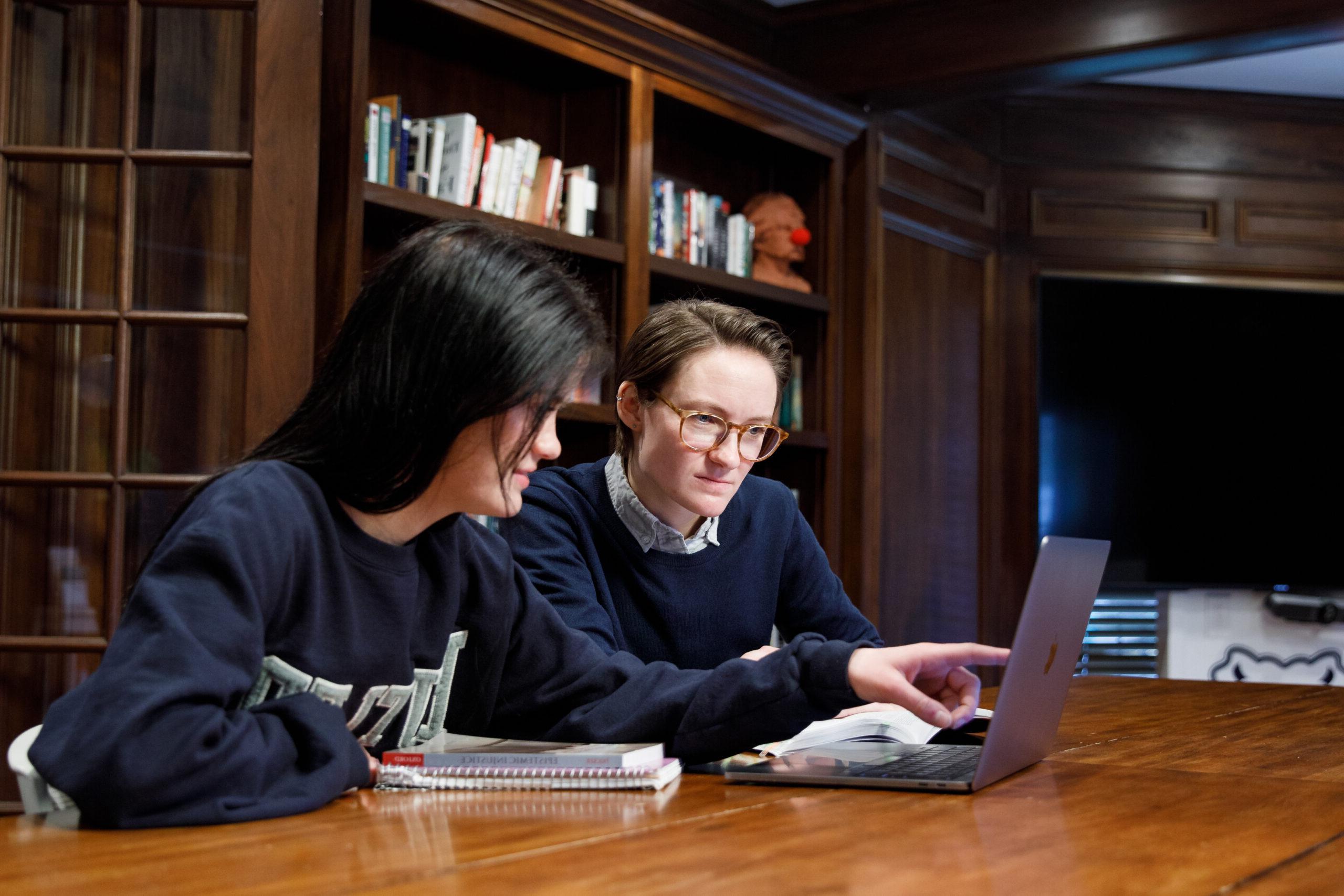 Faculty member and student talking about an assignment.